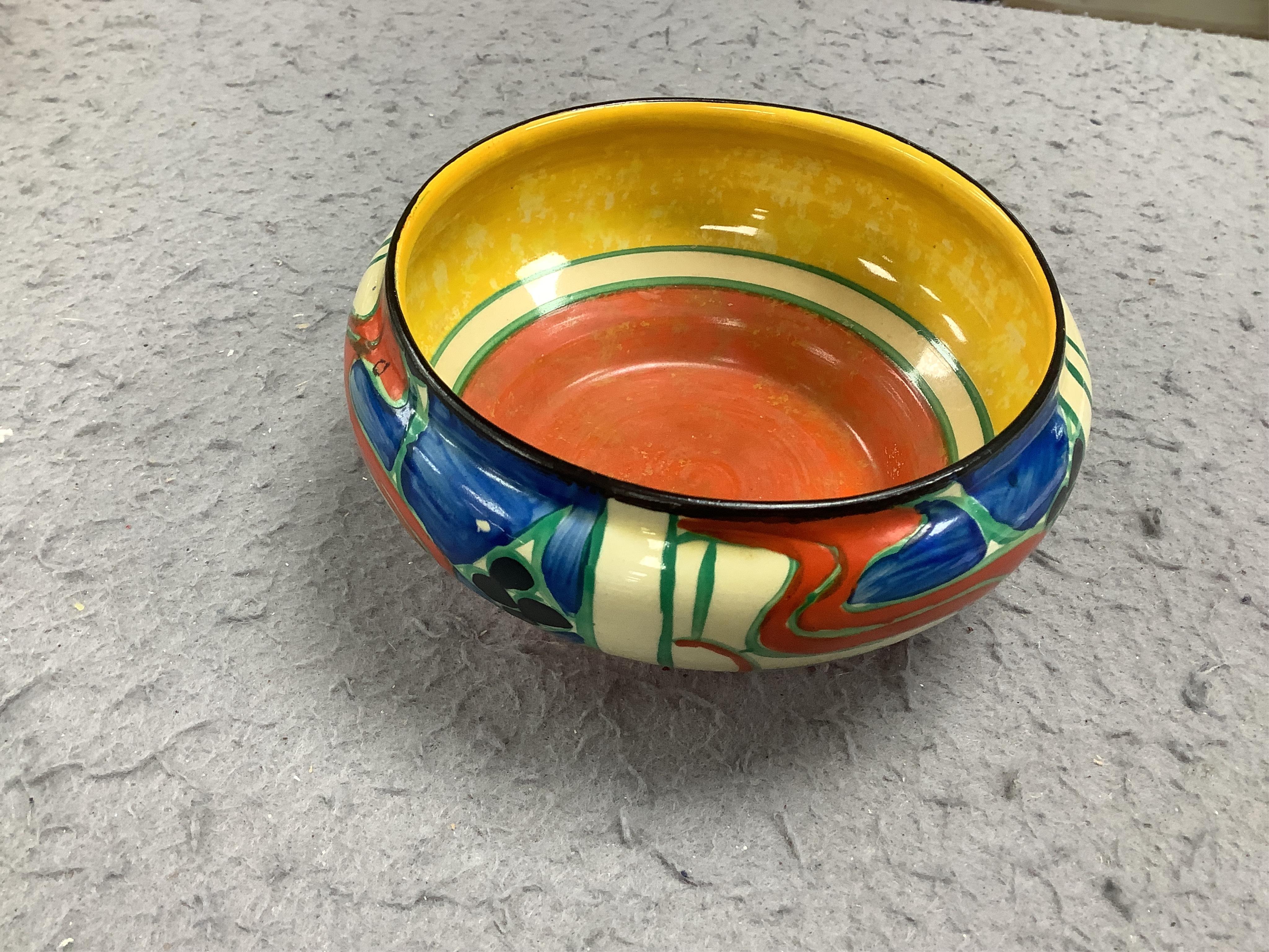 A small Clarice Cliff 'Fantasque' bowl, top rim 11cm diameter. Condition - minor chips to enamelling.